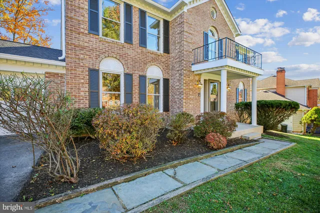 a view of an empty room with a chandelier fan