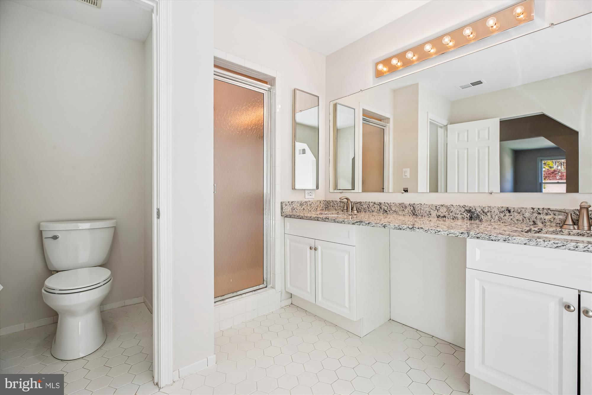 17 Locustwood Court Silver Spring, MD 20905 - Photo 37 of 72 a bathroom with a granite countertop sink mirror and a toilet