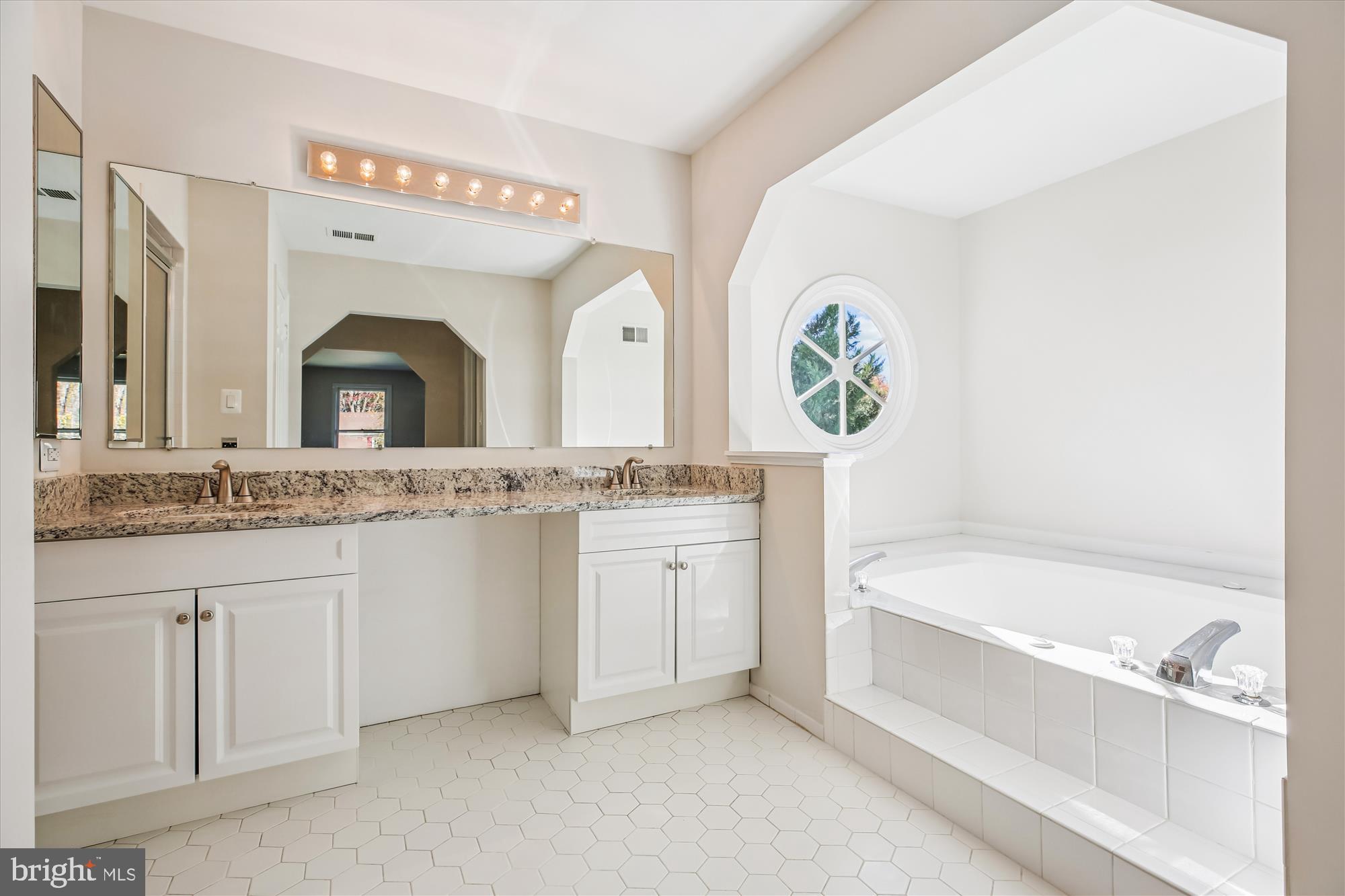 17 Locustwood Court Silver Spring, MD 20905 - Photo 39 of 72 a bathroom with a granite countertop sink mirror and bathtub