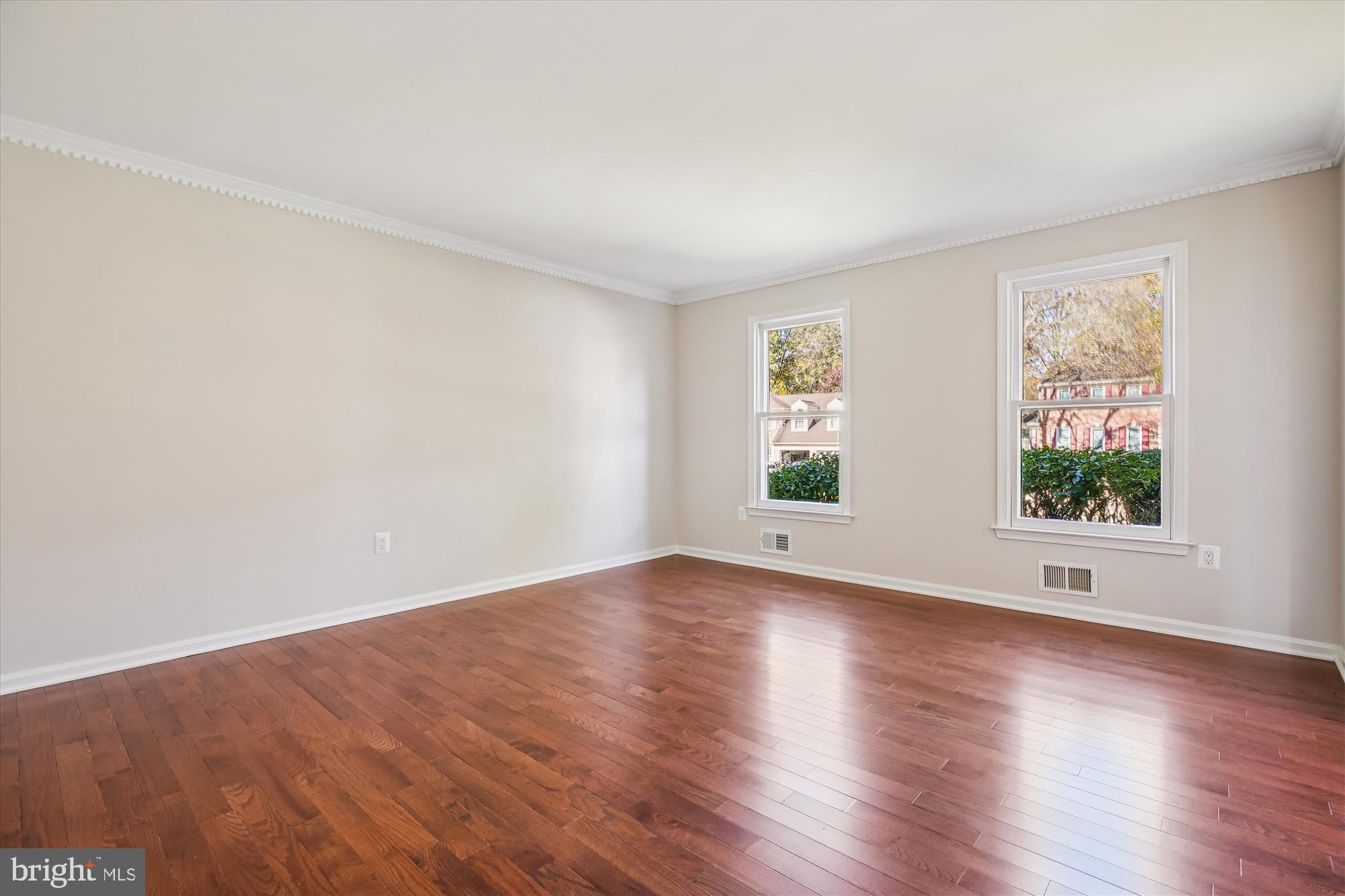 17 Locustwood Court Silver Spring, MD 20905 - Photo 10 of 72 a view of an empty room with wooden floor and a window