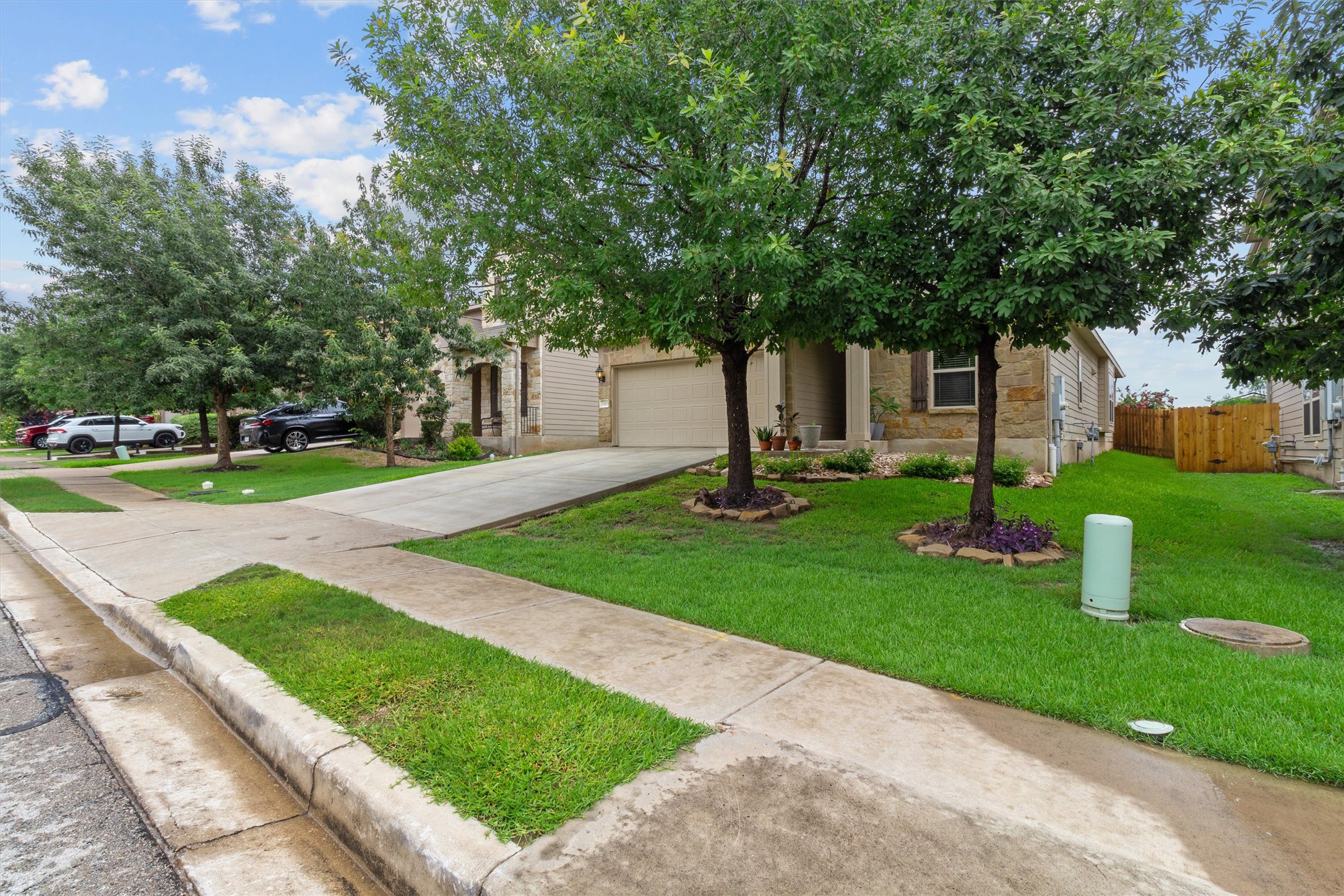 10413 Crescendo Lane Austin, TX 78747 - Photo 3 of 32 A traditional home with a well-maintained lawn and a private driveway leads to the attached garage.
