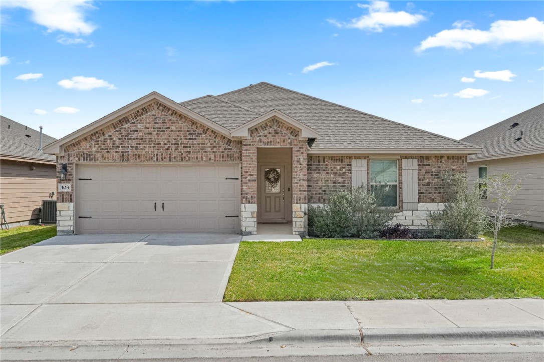 103 Donegal Street Sinton, TX 78387 - Photo 1 of 29 a front view of a house with a yard and garage
