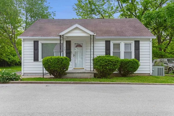 a view of a house with a yard and plants