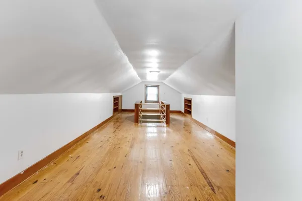 a view of a room with wooden floor