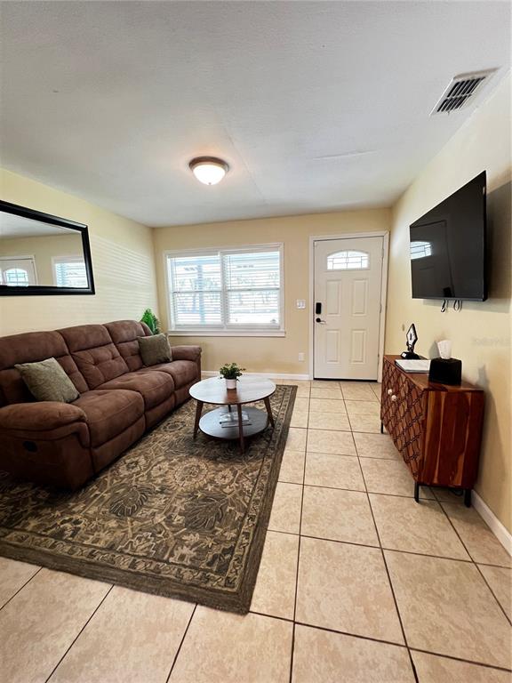 138 Woods Road San Mateo, FL 32187 - Photo 6 of 9 a living room with furniture and a flat screen tv