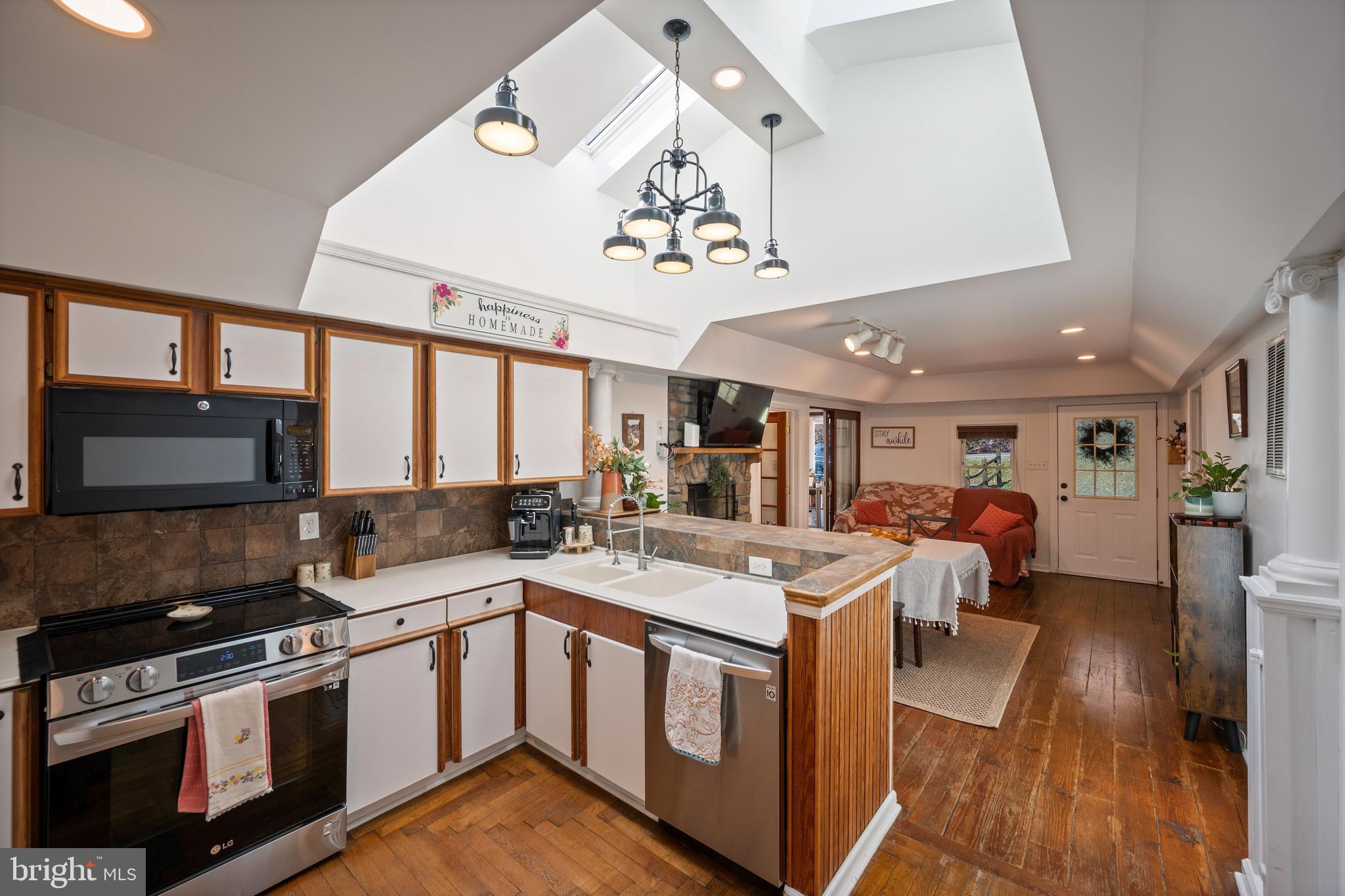 13403 Catoctin Furnace Road Thurmont, MD 21788 - Photo 60 of 60 a kitchen with a stove a microwave and wooden floor