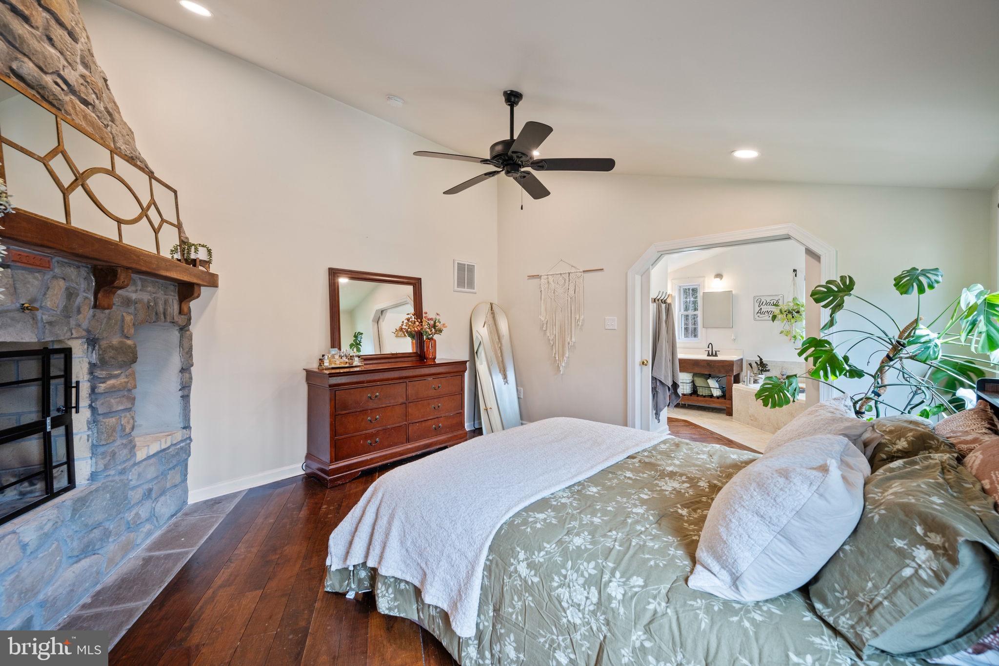 13403 Catoctin Furnace Road Thurmont, MD 21788 - Photo 15 of 60 a bedroom with a bed and a chandelier