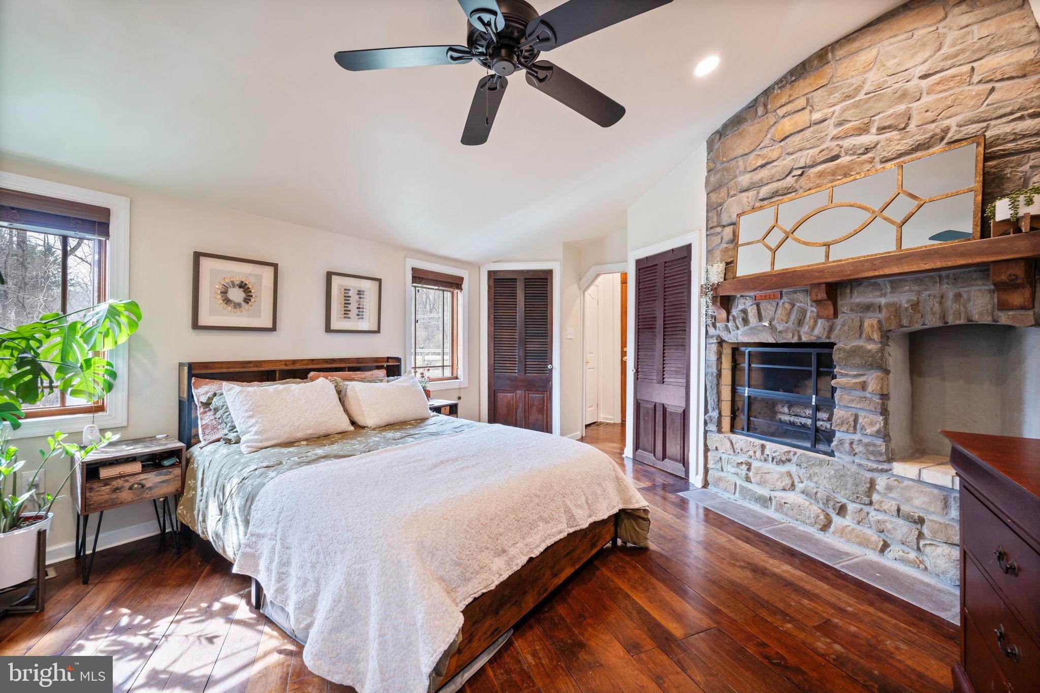 13403 Catoctin Furnace Road Thurmont, MD 21788 - Photo 17 of 60 a spacious bedroom with a bed a dresser and with a chandelier