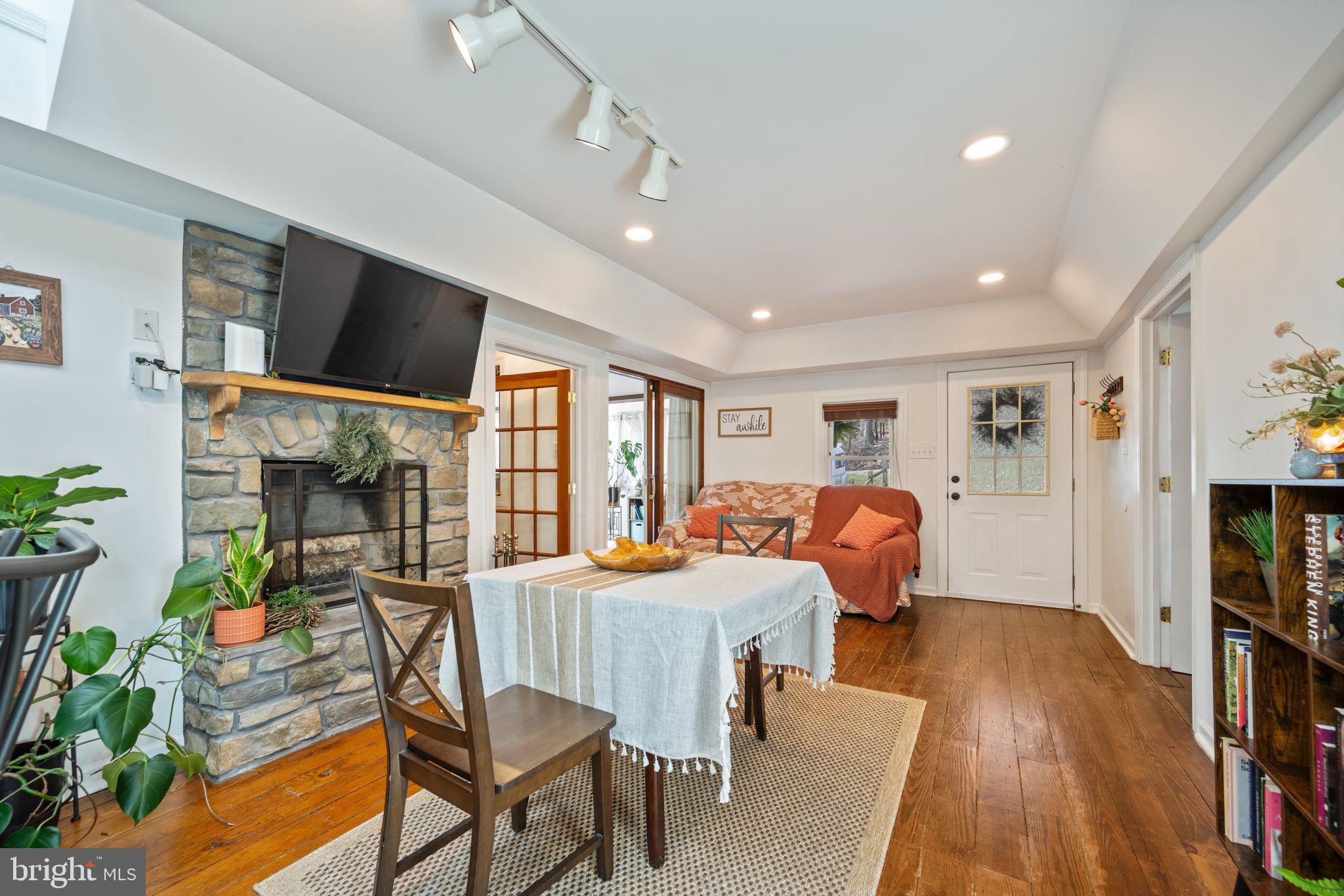 13403 Catoctin Furnace Road Thurmont, MD 21788 - Photo 5 of 60 a dining room with furniture a flat screen tv and wooden floor