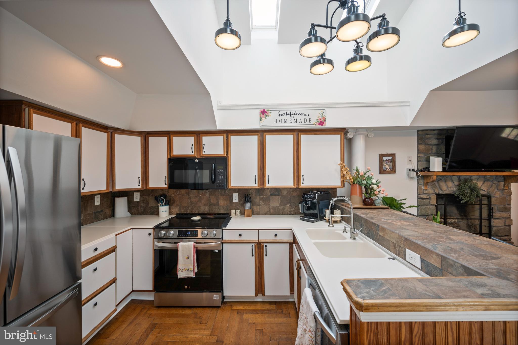 13403 Catoctin Furnace Road Thurmont, MD 21788 - Photo 7 of 60 a kitchen with a sink stove and refrigerator
