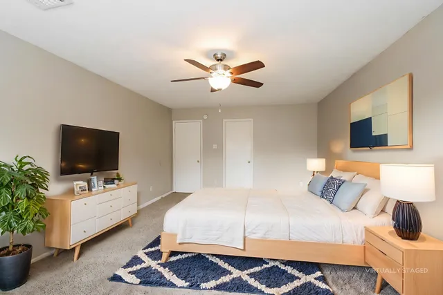 a bedroom with a bed and flat screen tv