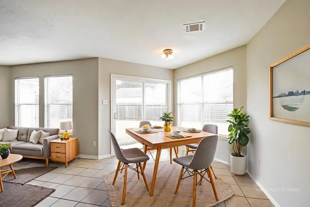 a dining room with furniture and window