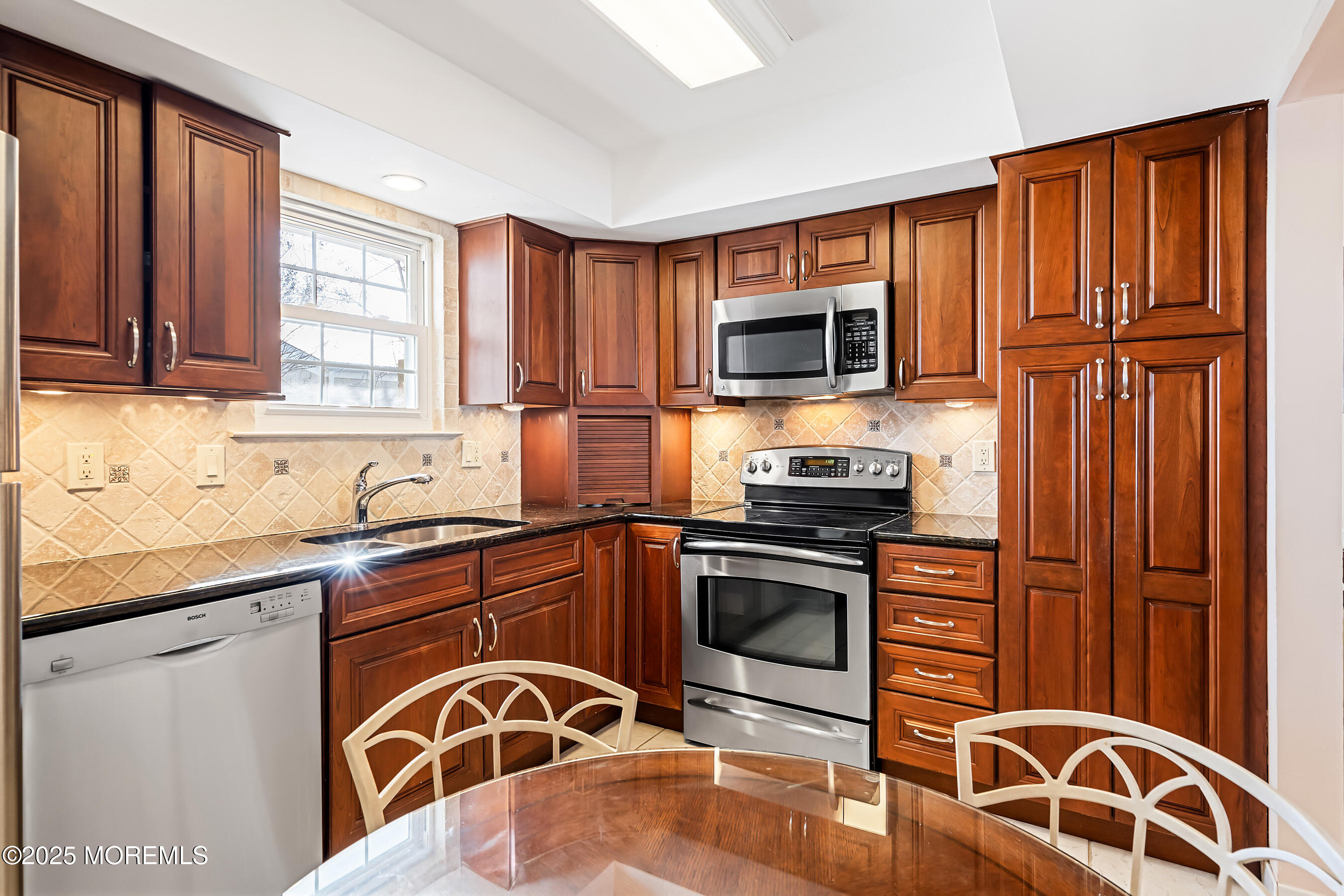 59 Walnut Drive Spring Lake Heights, NJ 07762 - Photo 12 of 59 a kitchen with granite countertop wooden cabinets stainless steel appliances and a window