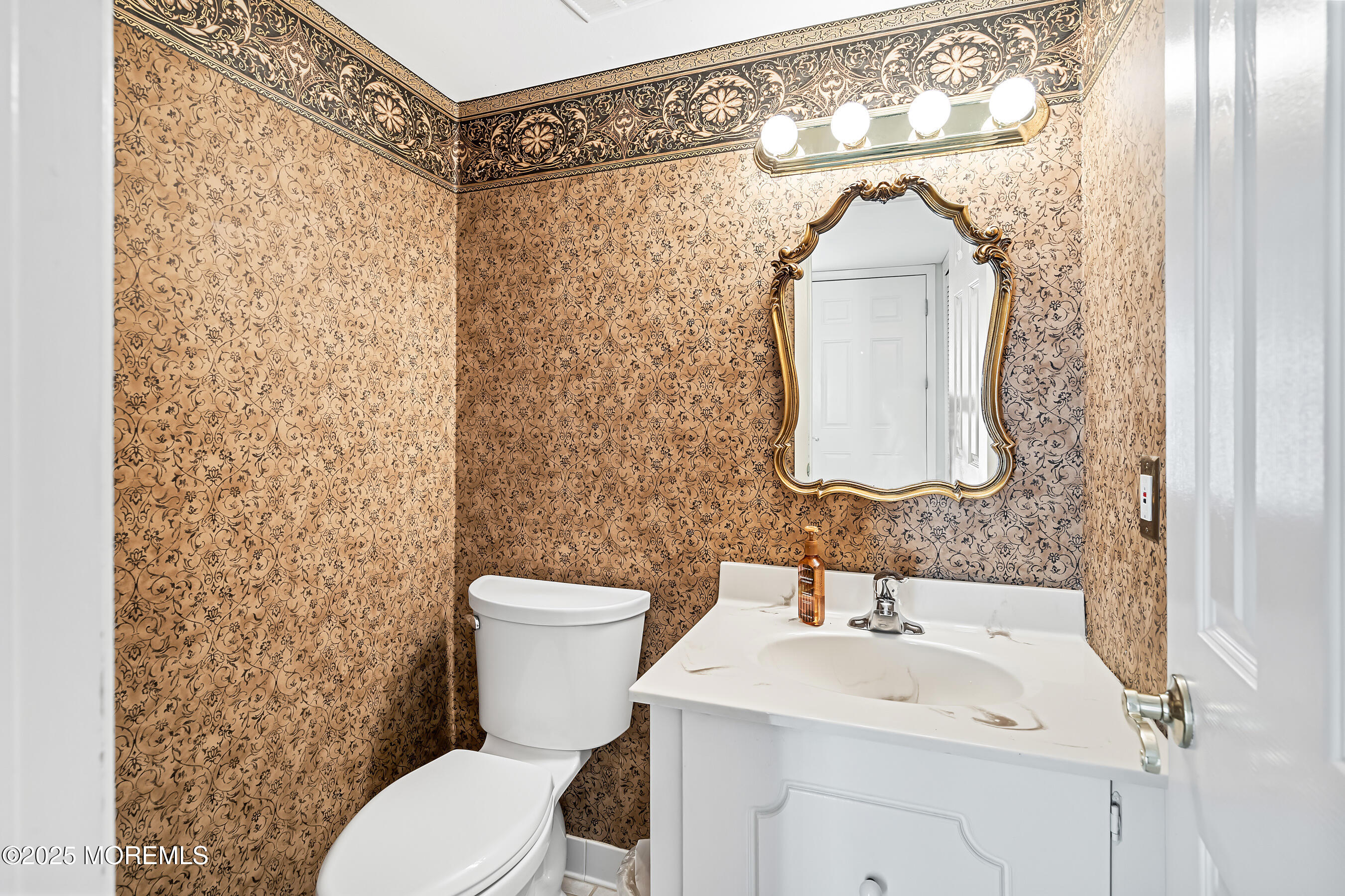 59 Walnut Drive Spring Lake Heights, NJ 07762 - Photo 15 of 59 a bathroom with a toilet sink and mirror