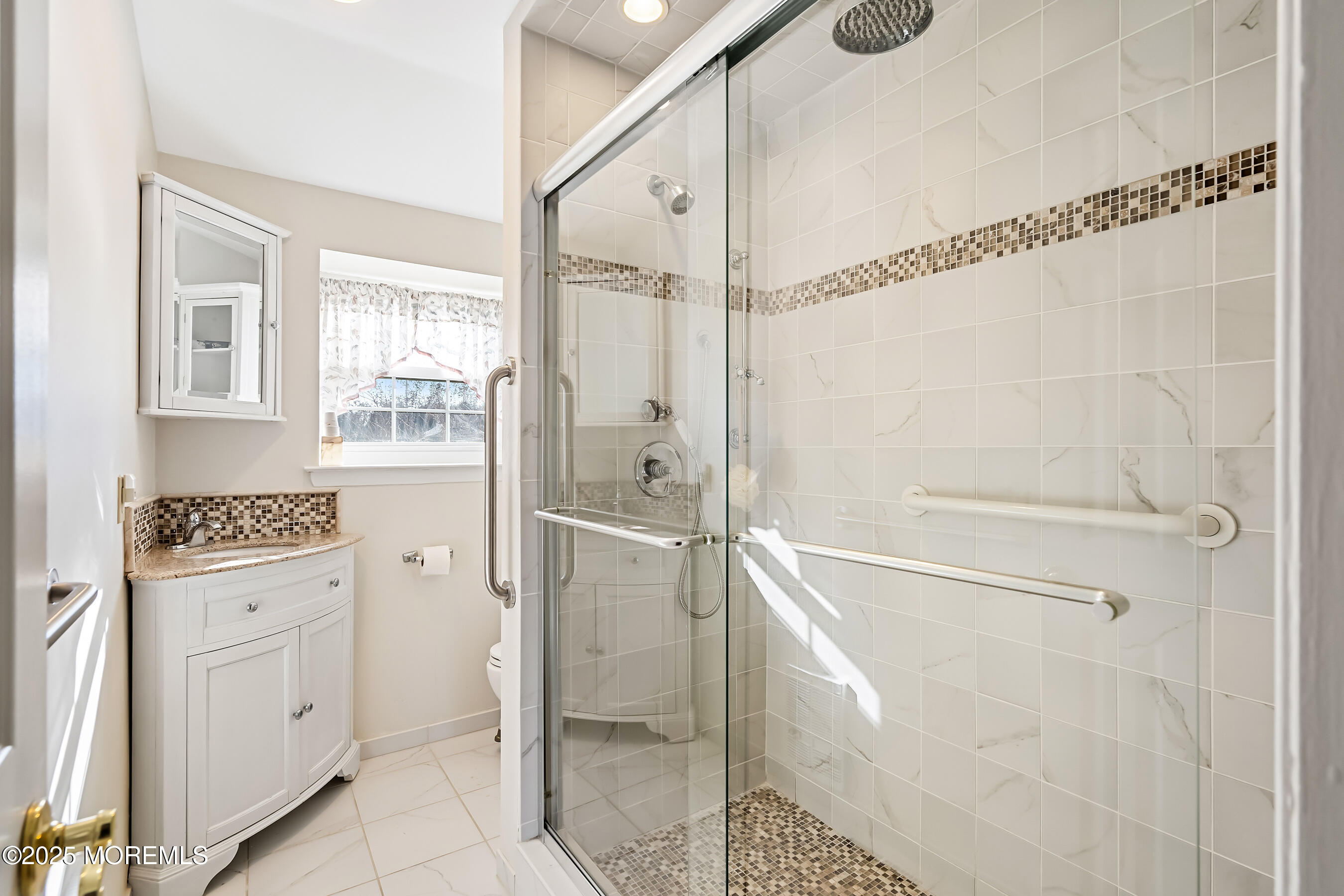 59 Walnut Drive Spring Lake Heights, NJ 07762 - Photo 22 of 59 a bathroom with a shower a sink and a mirror