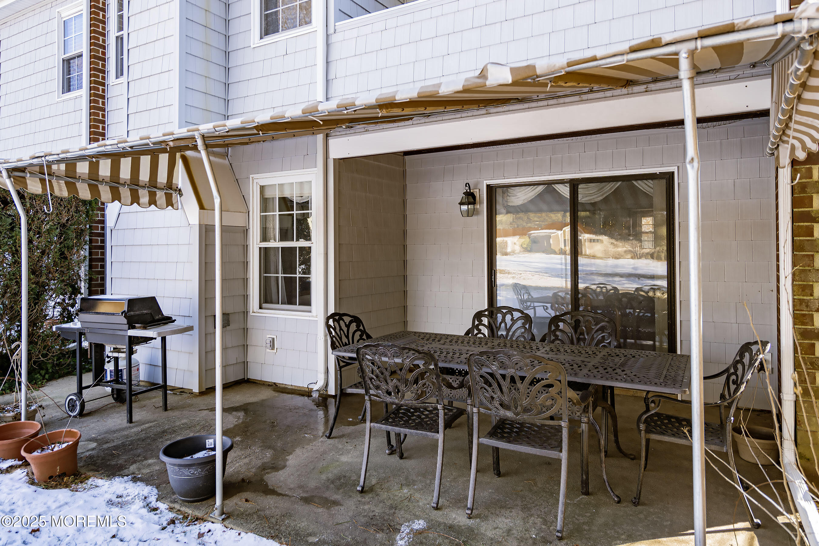 59 Walnut Drive Spring Lake Heights, NJ 07762 - Photo 27 of 59 a view of a patio with table and chairs and potted plants