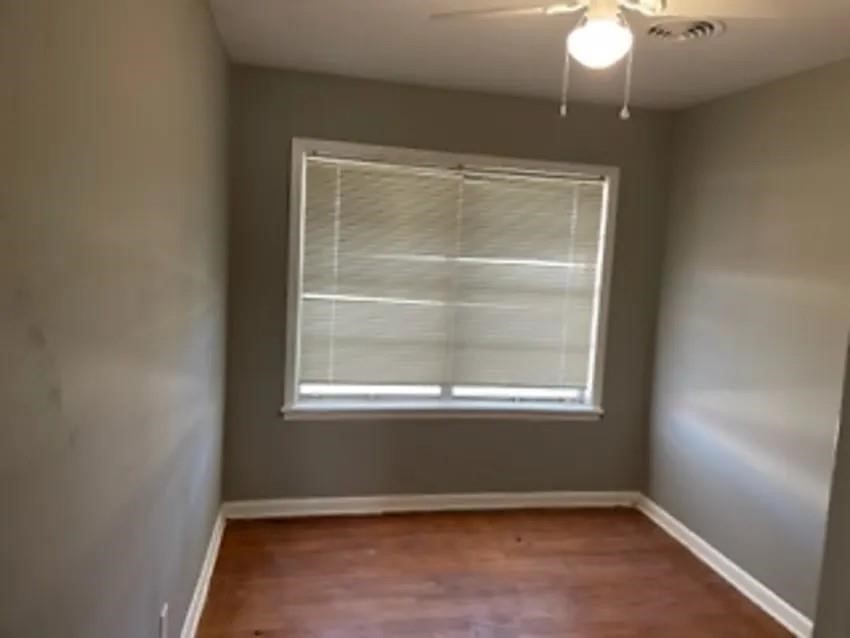 105 Dooley Street Prairie View, TX 77446 - Photo 7 of 8 an empty room with wooden floor and windows