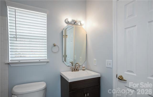 815 Knightsbridge Road Fort Mill, SC 29708 - Photo 18 of 30 a bathroom with a toilet a sink and mirror