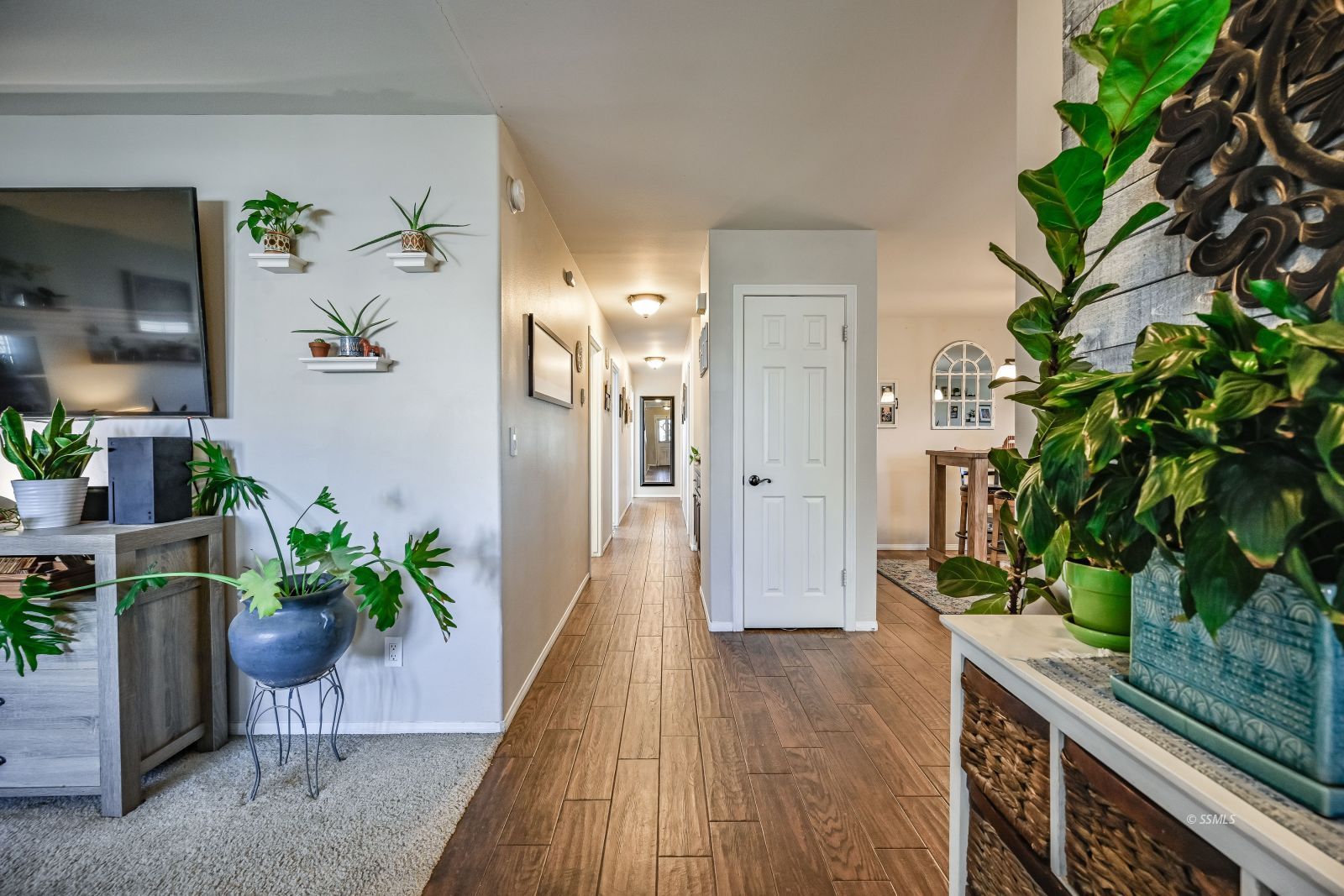 424 Marlene Court Ridgecrest, CA 93555 - Photo 11 of 38 a hallway with potted plants and wooden floor