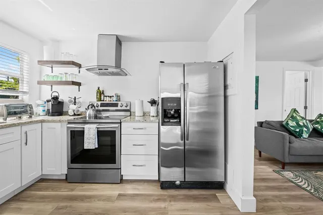 a kitchen with stainless steel appliances granite countertop a stove and a sink