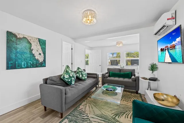 a view of a dining room with furniture a rug and a window