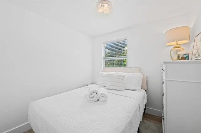 a room with a bed and a table in it