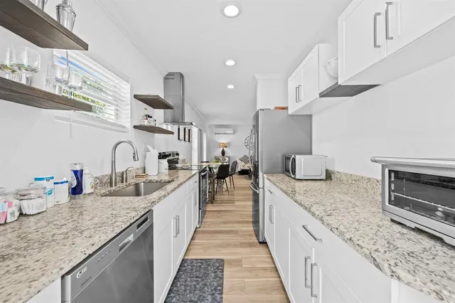 a kitchen with stainless steel appliances granite countertop a stove and a sink