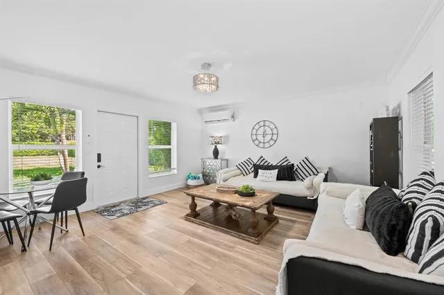 a living room with furniture a rug and a window