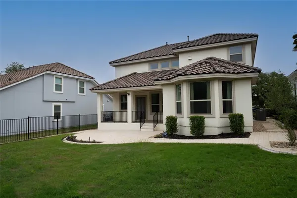 a view of a house with a yard and sitting area