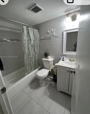 a bathroom with a toilet sink and shower