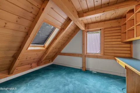 a view of a house with a wooden deck