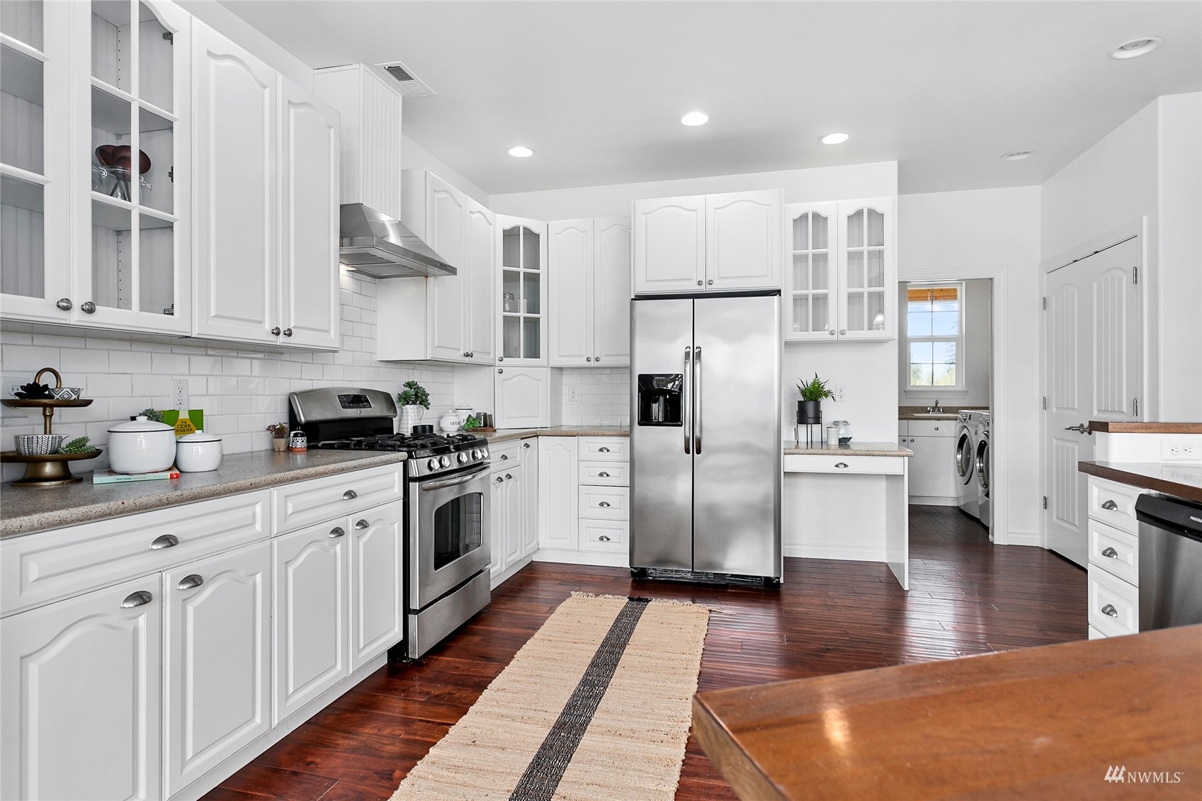 4906 Graveline Road Bellingham, WA 98226 - Photo 11 of 30 a kitchen with white cabinets and white appliances