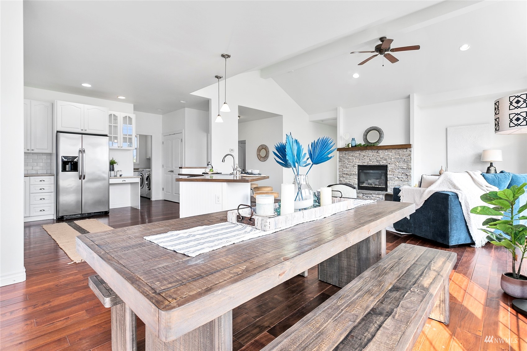 4906 Graveline Road Bellingham, WA 98226 - Photo 12 of 30 a open kitchen with granite countertop a stove a sink a kitchen island with wooden floor and chandelier