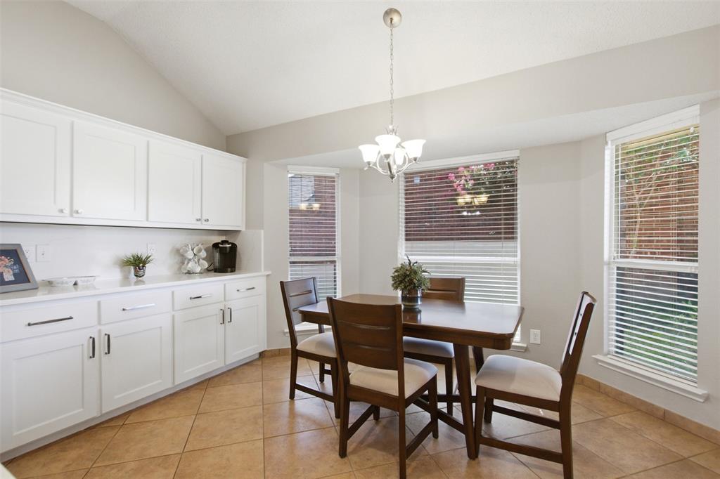 4218 Glistening Spring Rowlett, TX 75088 - Photo 16 of 39 Dining area featuring a vaulted ceiling and tile flooring