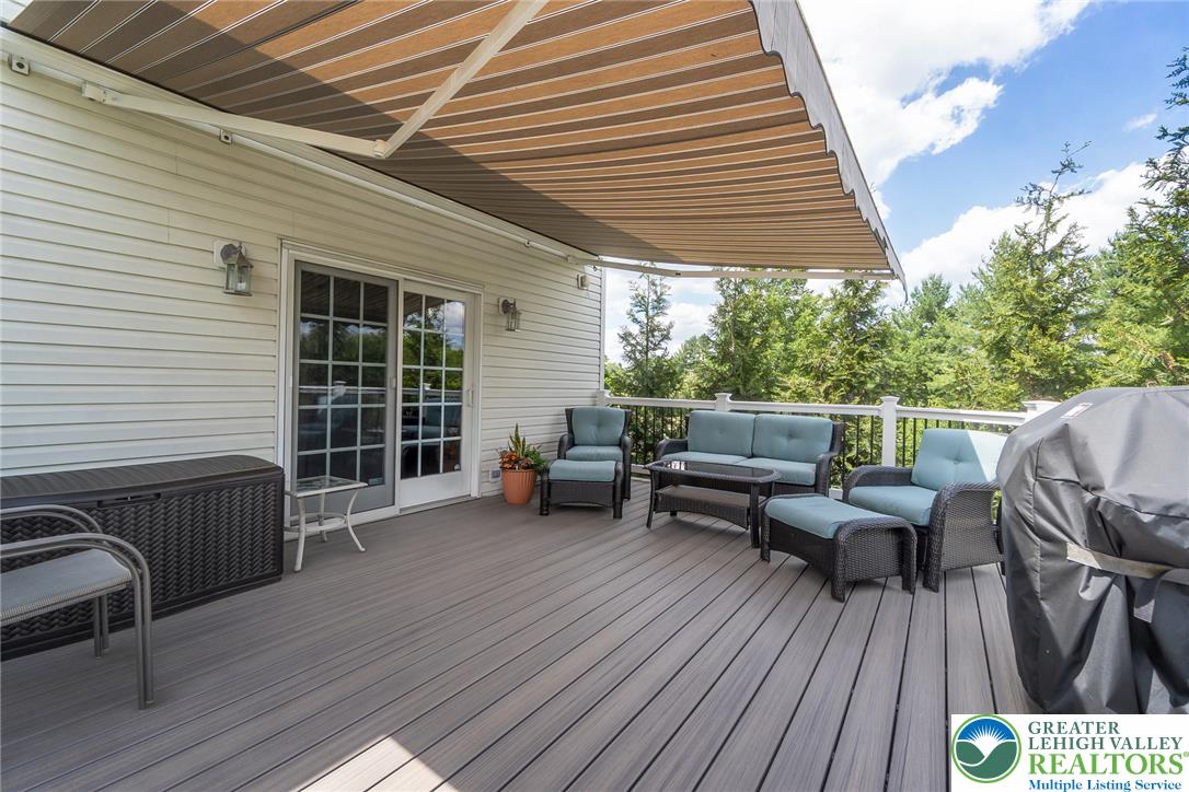 1795 Freier Road Quakertown, PA 18951 - Photo 42 of 69 An inviting deck, complete with a retractable awning, offers ample space for outdoor enjoyment.