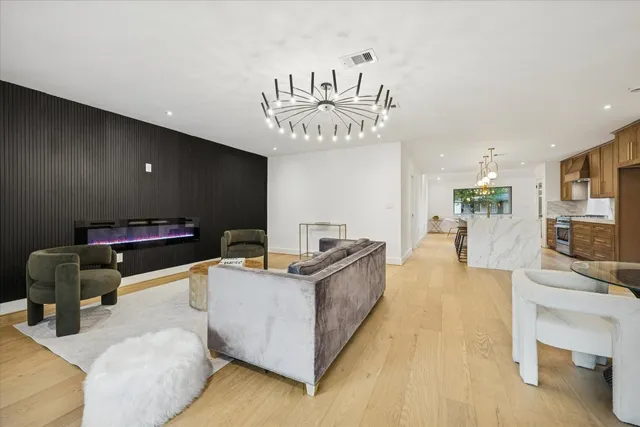 a living room with furniture and a chandelier