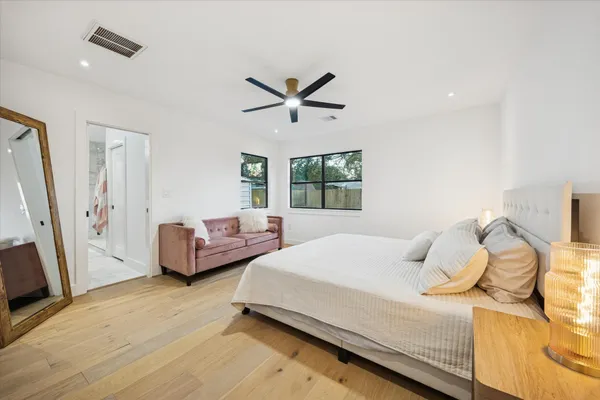 a bedroom with a bed and a window