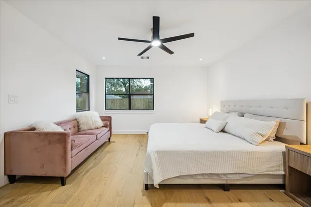 a bedroom with a large bed and a couch