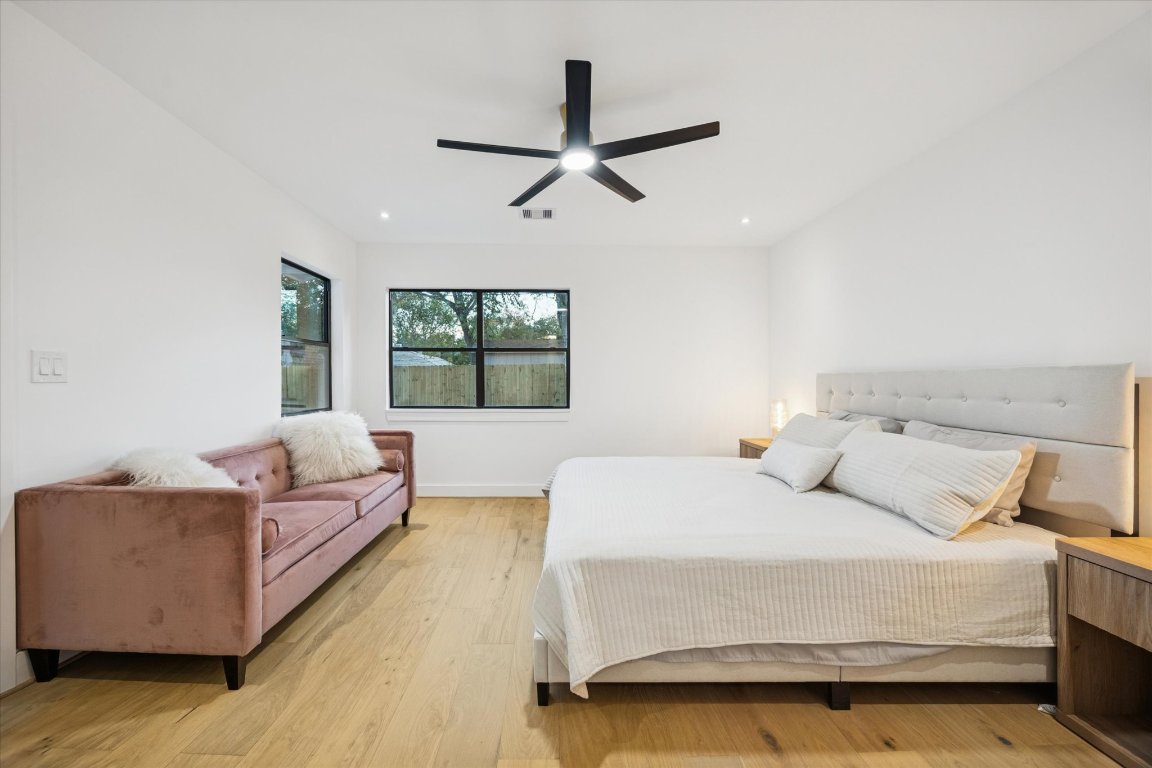 1611 Ridgehaven Drive Austin, TX 78723 - Photo 18 of 35 a bedroom with a large bed and a couch