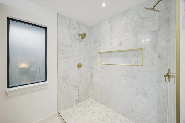 a bathroom with a glass shower door