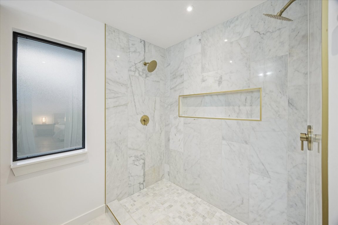 1611 Ridgehaven Drive Austin, TX 78723 - Photo 20 of 35 a bathroom with a glass shower door