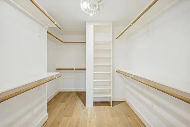 a view of walk in closet with empty racks