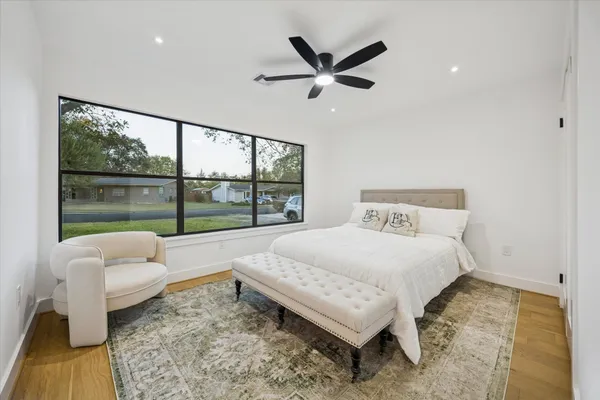 a bedroom with a bed and glass window