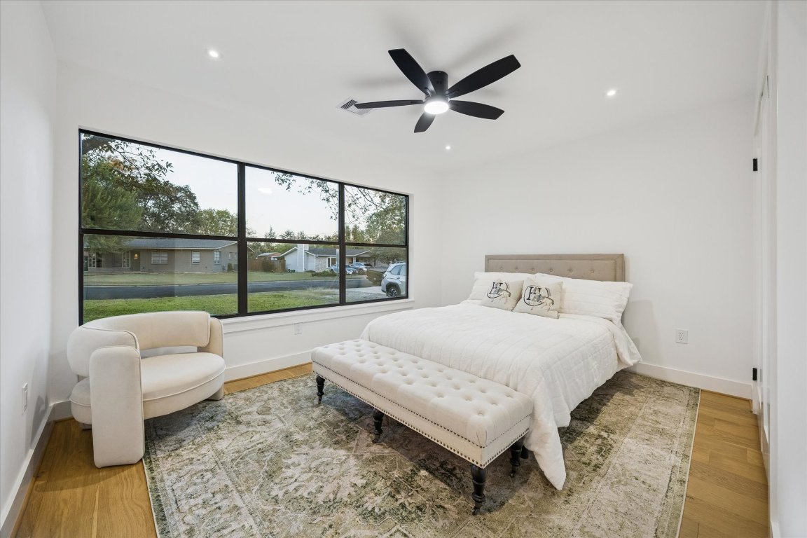 1611 Ridgehaven Drive Austin, TX 78723 - Photo 22 of 35 a bedroom with a bed and glass window