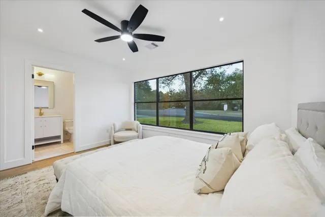 a bed room with a bed and a large window