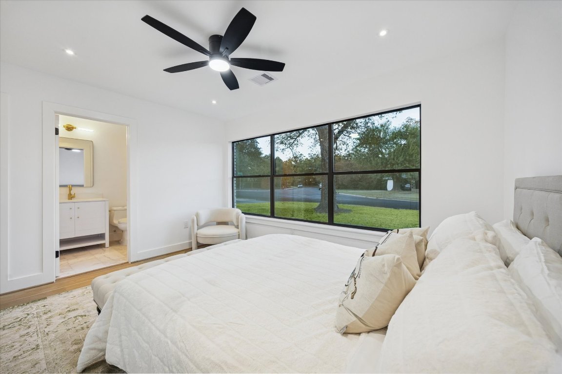 1611 Ridgehaven Drive Austin, TX 78723 - Photo 23 of 35 a bed room with a bed and a large window