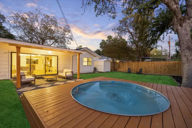 a view of a house with pool and a yard
