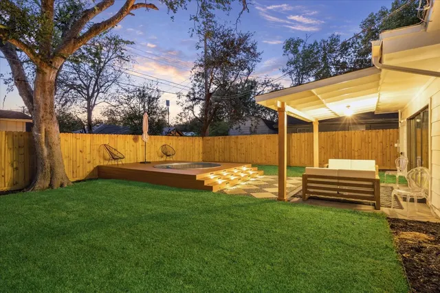 a view of a house with a backyard