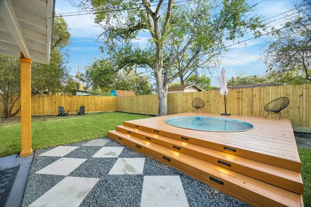 a view of a backyard with swimming pool
