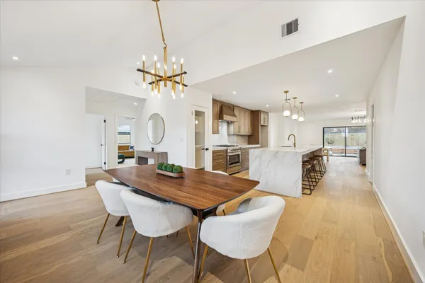 a view of a dining room with furniture and wooden floor